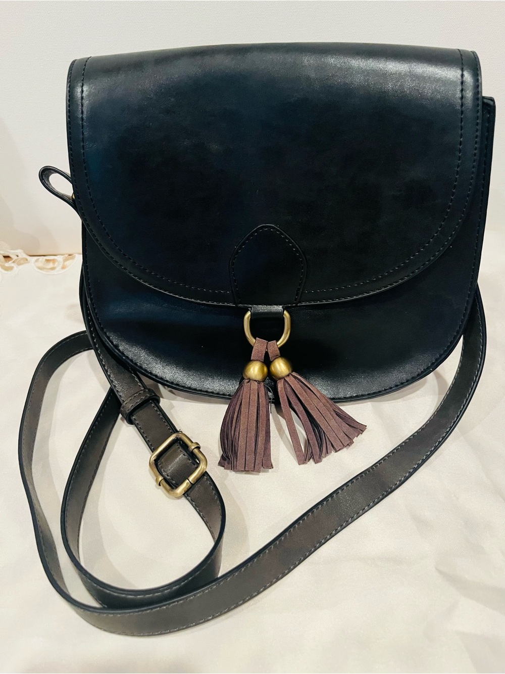 Black Leather Crossbody Bag with Brown Tassel Detail